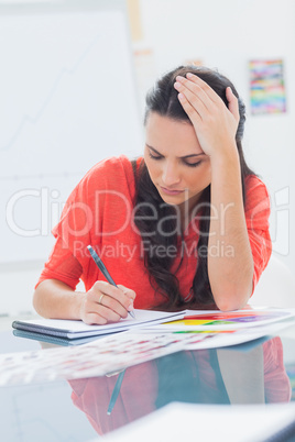 Overworked designer holding her head