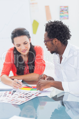 Two designers working on a colour wheel