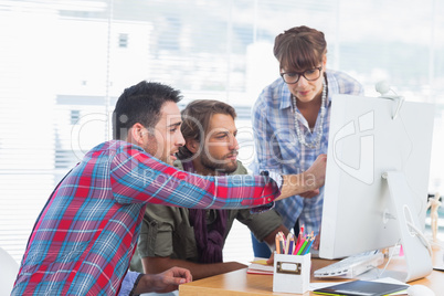 Team of designers working on a computer