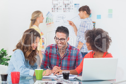 Cheerful designers brainstorming together Cheerful designers brainstorming together