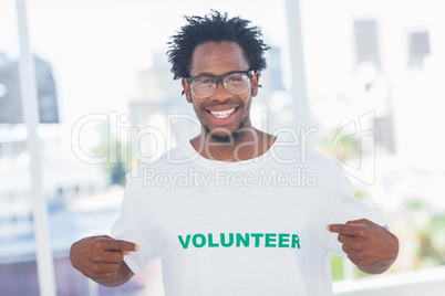 Handsome man pointing to his volunteer tshirt