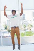 Man jumping with volunteer tshirt then raising his arms