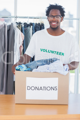 Handsome man holding a donation box