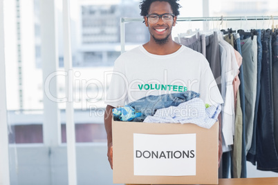 Attractive man holding a donation box