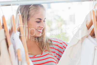 Cheerful woman looking at clothes