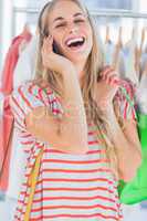 Blonde woman laughing in a clothing store
