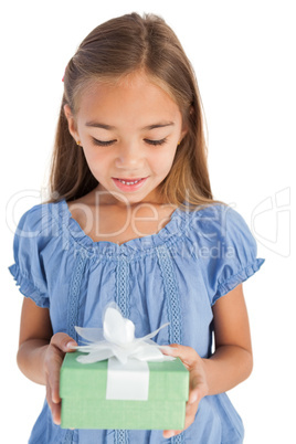 Cute little girl holding a wrapped gift