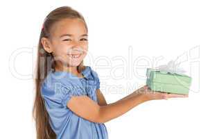 Cheerful little girl giving a present