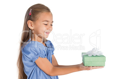 Blonde little girl giving a present