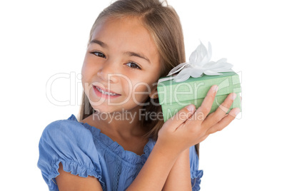 Smiling girl excited while holding a present