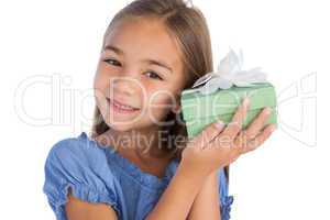 Smiling girl excited while holding a present