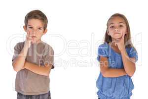 Thoughtful children standing with arms crossed