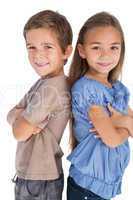 Children standing back to back with their arms crossed