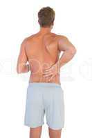 Man with shorts suffering from back pain