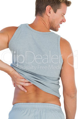 Man in tank top rubbing his back because of a back pain