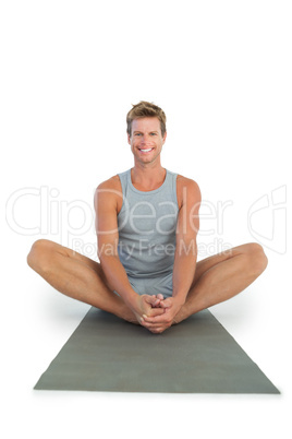 Handsome man sitting in lotus position