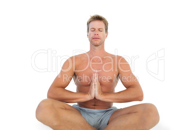 Man doing yoga and meditating on the floor