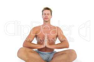 Man doing yoga and meditating on the floor