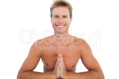 Cheerful man doing yoga and meditating