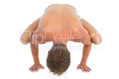 Man doing a crane pose during a yoga session