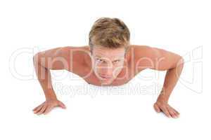 Shirtless man doing push ups