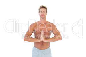 Shirtless man meditating