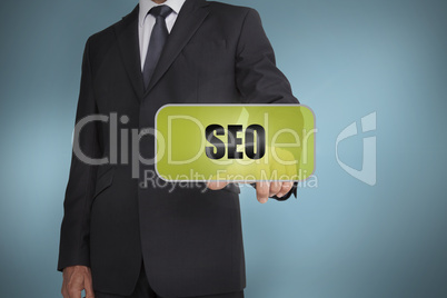 Businessman selecting green label with seo written on it