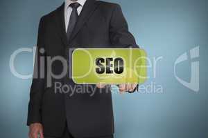 Businessman selecting green label with seo written on it