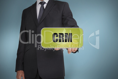 Businessman selecting green label with crm written on it