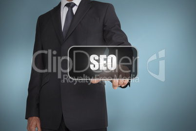 Businessman touching the word seo