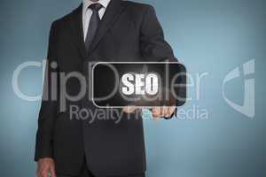 Businessman touching the word seo