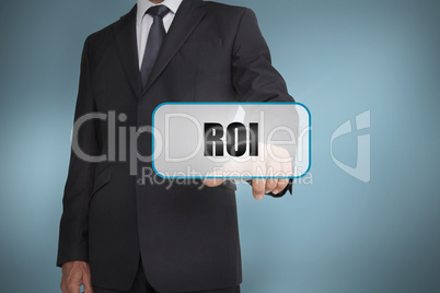Businessman touching tag with roi written on it