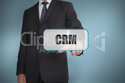 Businessman touching tag with crm written on it