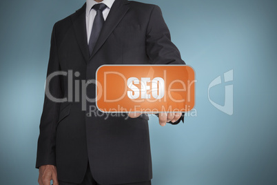 Businessman selecting orange tag with the word seo written on it