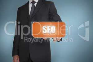 Businessman selecting orange tag with the word seo written on it