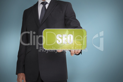 Businessman touching green tag with the word seo written on it