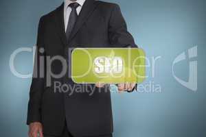 Businessman touching green tag with the word seo written on it