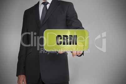 Businessman selecting green tag with the word crm written on it