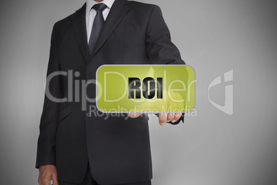 Businessman selecting green tag with the word roi written on it
