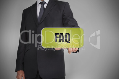 Businessman selecting green tag with the word faq written on it