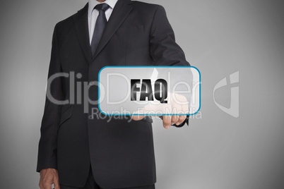 Businessman touching white tag with the word faq written on it