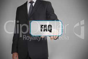 Businessman touching white tag with the word faq written on it