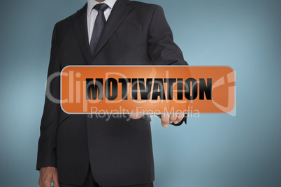 Businessman touching the word motivation