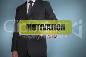 Businessman touching the word motivation written on green tag