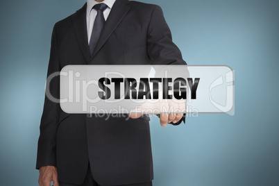 Businessman selecting the word strategy written on white tag