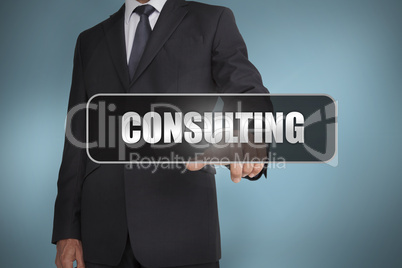 Businessman touching the word consulting written on black tag