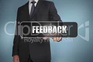 Businessman touching the word feedback written on black tag