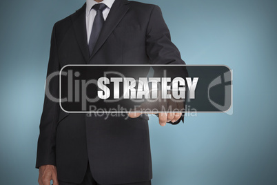 Businessman touching the word strategy written on black tag