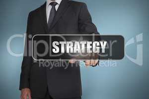 Businessman touching the word strategy written on black tag