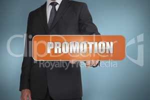 Businessman selecting the word promotion written on orange tag